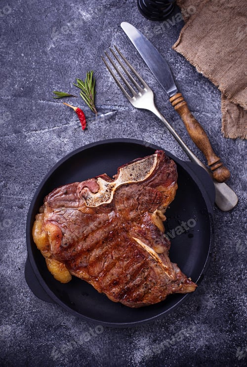 Preview: Grilled T-bone steak on dark background