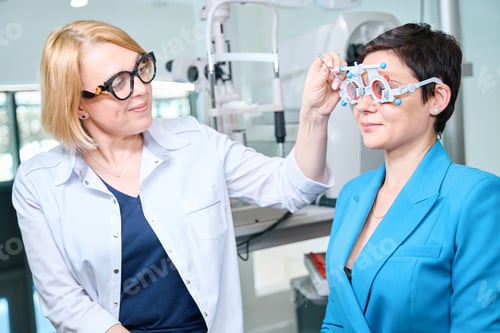 Preview: Ophthalmologist performing monocular subjective refraction test in adult woman