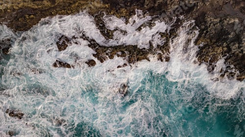 Preview: Atlantic ocean with strong swell beating against the walls of a rocky cliff, blue rough sea