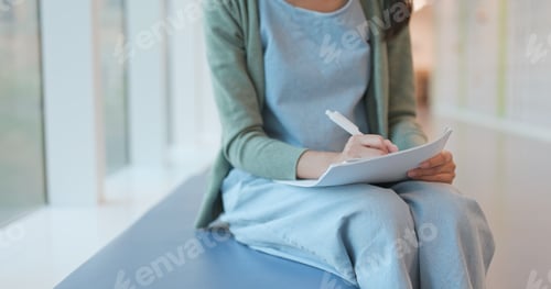 Preview: Close up of woman reading on note at school