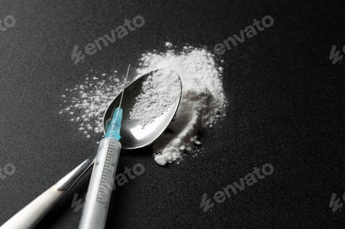 Preview: Spoon with cocaine powder and syringe on dark background. Space for text