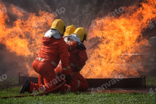 Preview: fire fighter team on training with gas and oil fire hold hose spray jet water spray to extinguish