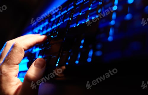 Preview: Man's hand typing on a blue keyboard