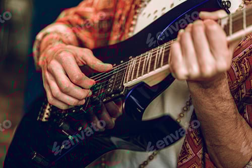 Preview: Close up photo of male hands playing guitar