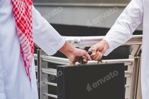 Preview: Handsome modern Arabian man standing in modern city wear muslim dress headscarf eastern ethnic