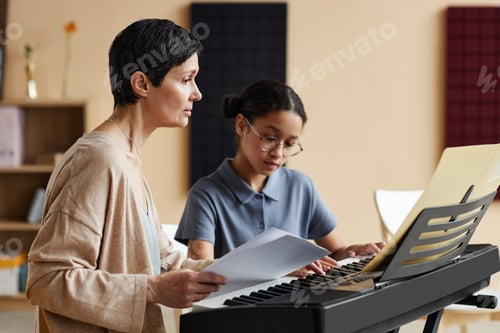 Preview: Teacher teaching notes student in music class