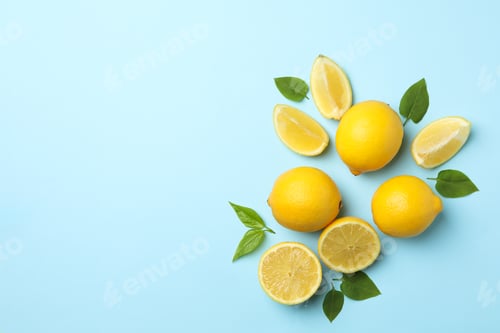Preview: Fresh lemons with leaves on blue background, top view. Ripe fruit