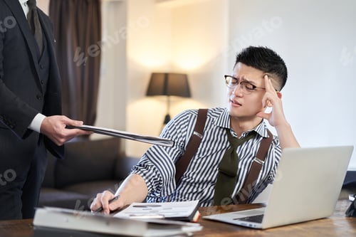 Preview: Asian businessman tired from adding work