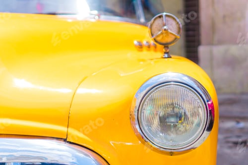 Preview: Closeup of yellow classic vintage car in Old Havana, Cuba