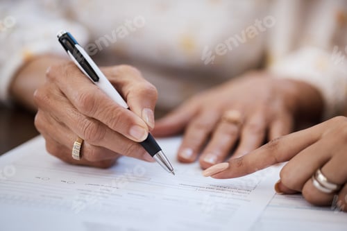 Preview: Shot of a woman going over paperwork with her elderly mother at home
