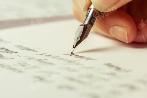 Preview: Writing with a fountain pen on white paper during the afternoon in a quiet setting