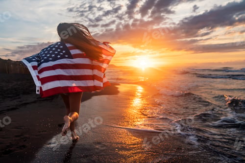 Preview: Happy woman holding american USA flag and running on the beach. Independence Day, travel concept