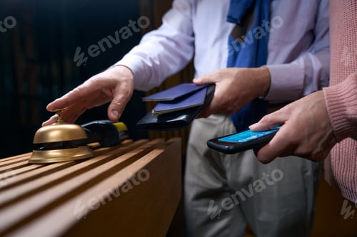 Preview: Man in travel clothes calls the hotel staff for registration