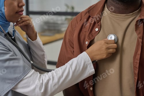 Preview: Female Medical Worker Checking Heartbeat of Her Patient with Stethoscope