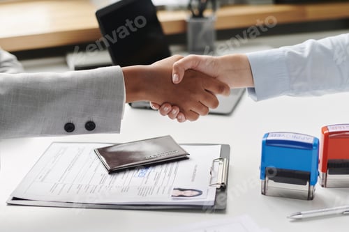 Preview: People shaking hands in visa agency