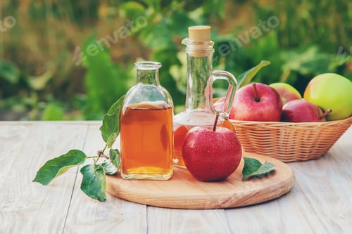 Preview: Apple cider vinegar in a bottle. Selective focus.