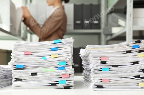 Preview: Stacks of documents with paper clips on office desk