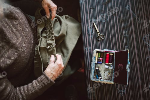 Preview: Senior woman with sewing kit, top view