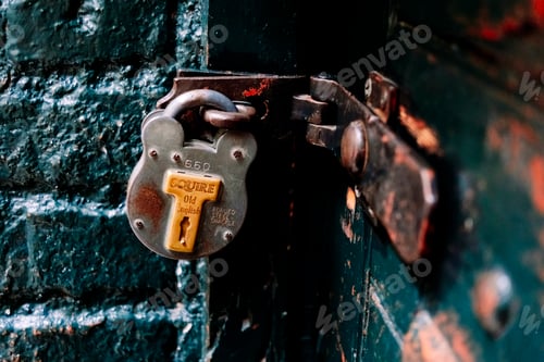 Preview: Vintage security padlock on a worn wooden door, rich textures