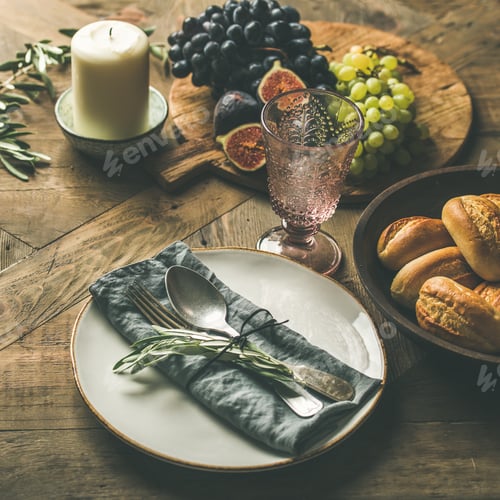 Preview: Plate with linen napkin, fork, spoon, glass, candle, fruits, bread