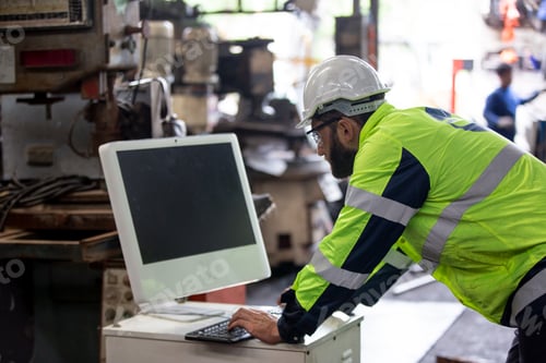 Preview: Portrait of industry worker doing work in factory.