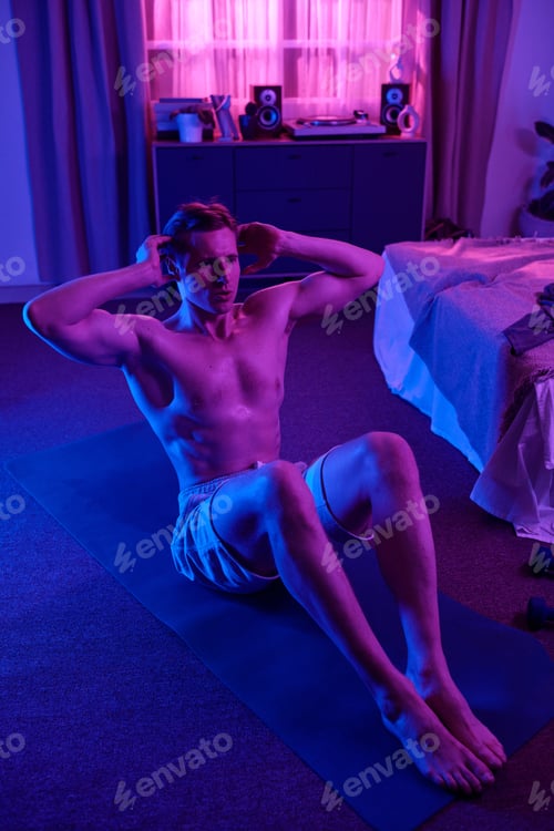 Preview: Man Exercising Abs on Yoga Mat in Home Bedroom Setting