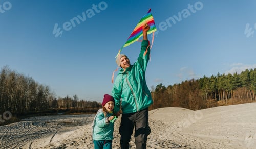 Preview: Father with his 5 years old daughter prepairing kite to fly
