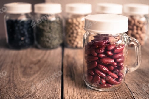 Preview: Red Beans In The Glass Bottle On The Old Wood Table
