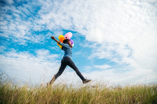Preview: Banner Cheerful cute girl holding balloons running green meadow white cloud blue sky happiness
