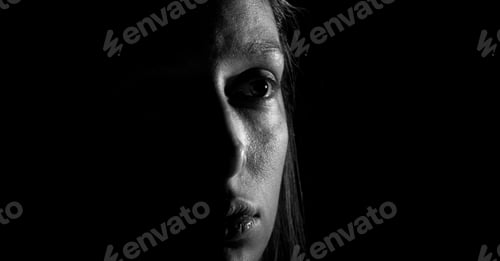 Preview: Low key photo of woman looking sad