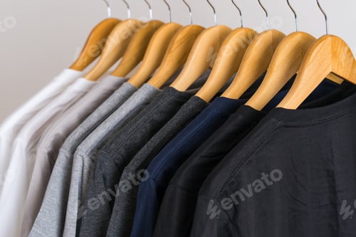 Preview: Close up of T-shirts on hangers, apparel background