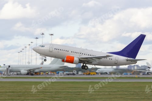 Preview: modern airliner taking off from runway, airplanes on background