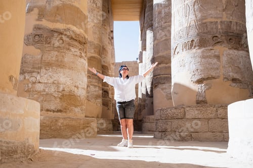 Preview: Woman traveler explores the ruins of the ancient Karnak temple in the city of Luxor in Egypt.