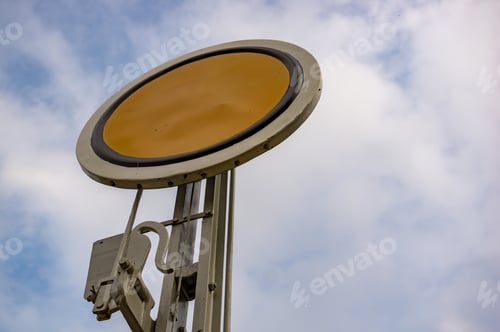 Preview: Low angle view of a yellow train station sign on a cloudy day