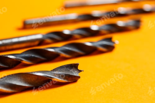Preview: Drills for wood of different sizes for a drill on an orange background. Construction tool