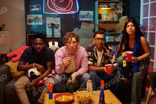 Preview: Group of Young Multiethnic Friends Watching Television and Eating Snacks