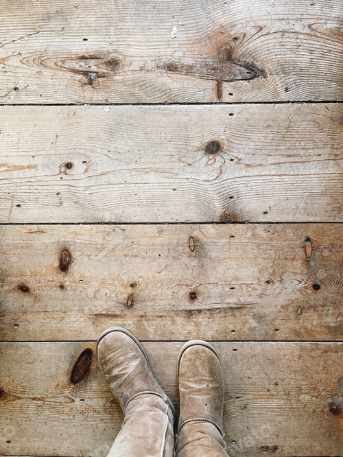Preview: Old rustic wood floors with someone standing in tan Uggs make a great background