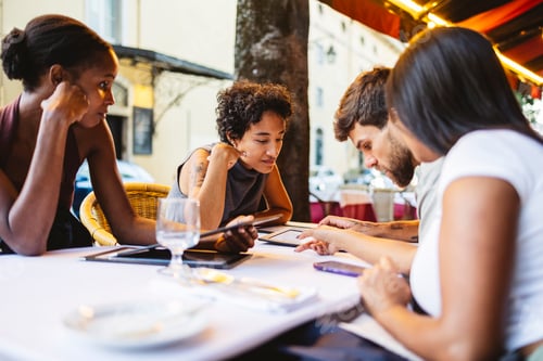 Preview: Business people working with digital tablet and smartphone at restaurant table