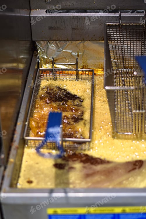 Preview: Deep frying fish fries or other food cooking in a restaurant fryer