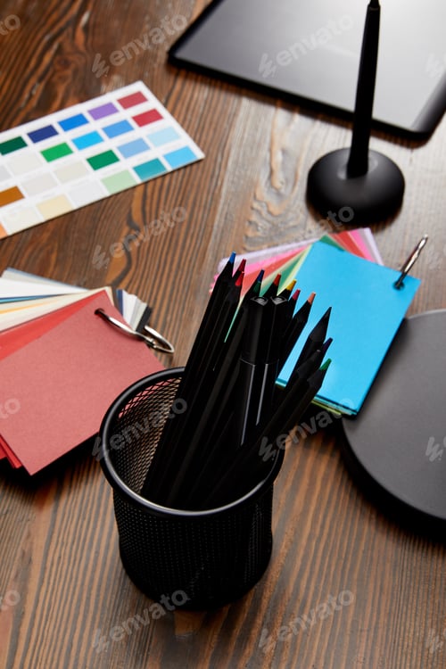 Preview: close up view of graphic designer workplace with colorful pallet and graphic tablet on wooden