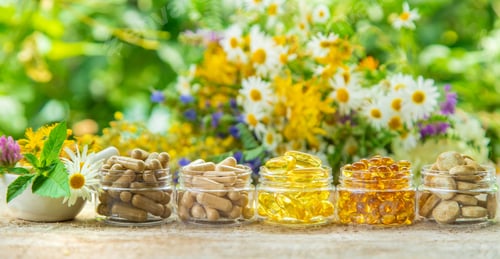 Preview: Supplements and vitamins with medicinal herbs. Selective focus.