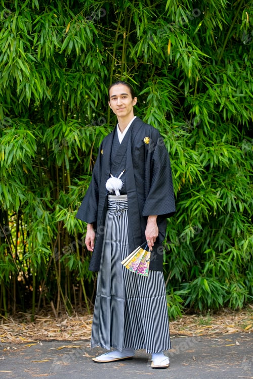 Preview: Man in traditional Japanese attire posing in front of bamboo