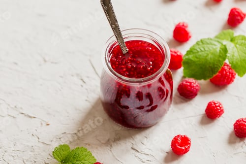 Preview: homemade raspberry jam on a concrete background with fresh raspberries