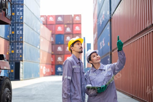 Preview: Portrait of an engineer checking products at an industrial container yard.