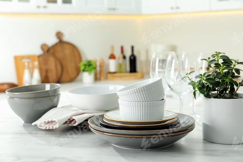 Preview: Set of beautiful tableware on white table in kitchen