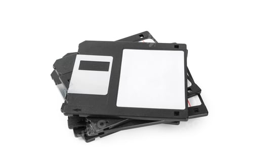 Preview: Collection of vintage floppy disks stacked on a white background in a simple arrangement