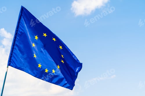 Preview: European Union flag against blue sky waving