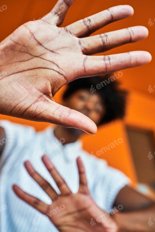 Preview: Serious black woman with hands raised protesting and trying to stop violence