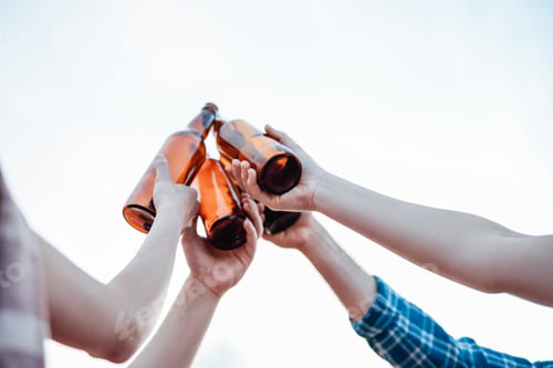 Preview: Friends raise and clink their brown bottles with beer