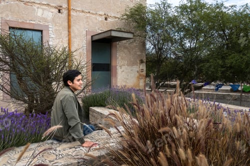 Preview: Man visiting the old rustic model school with cactus in Mineral de Pozos Guanajuato Mexico